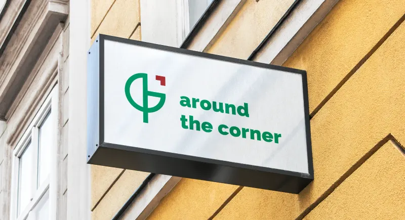Around the Corner logo mark on a green field.