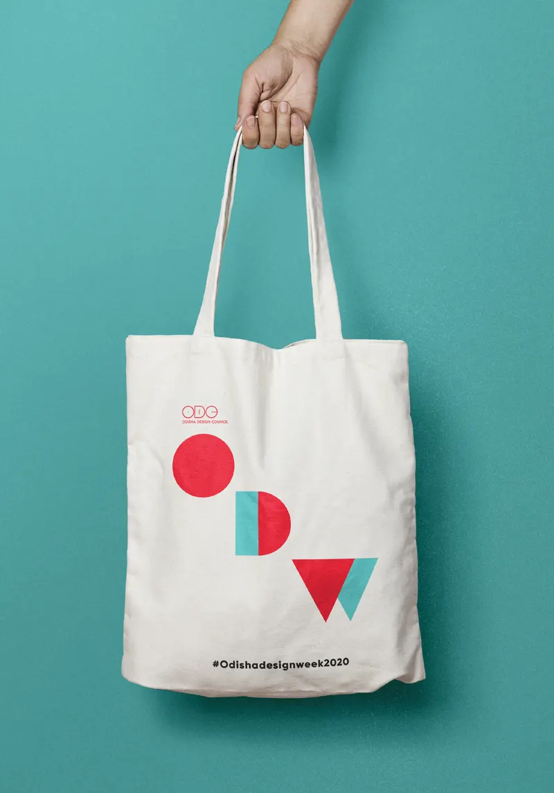 Extended brand applications: merchandise, badges, and printed materials.